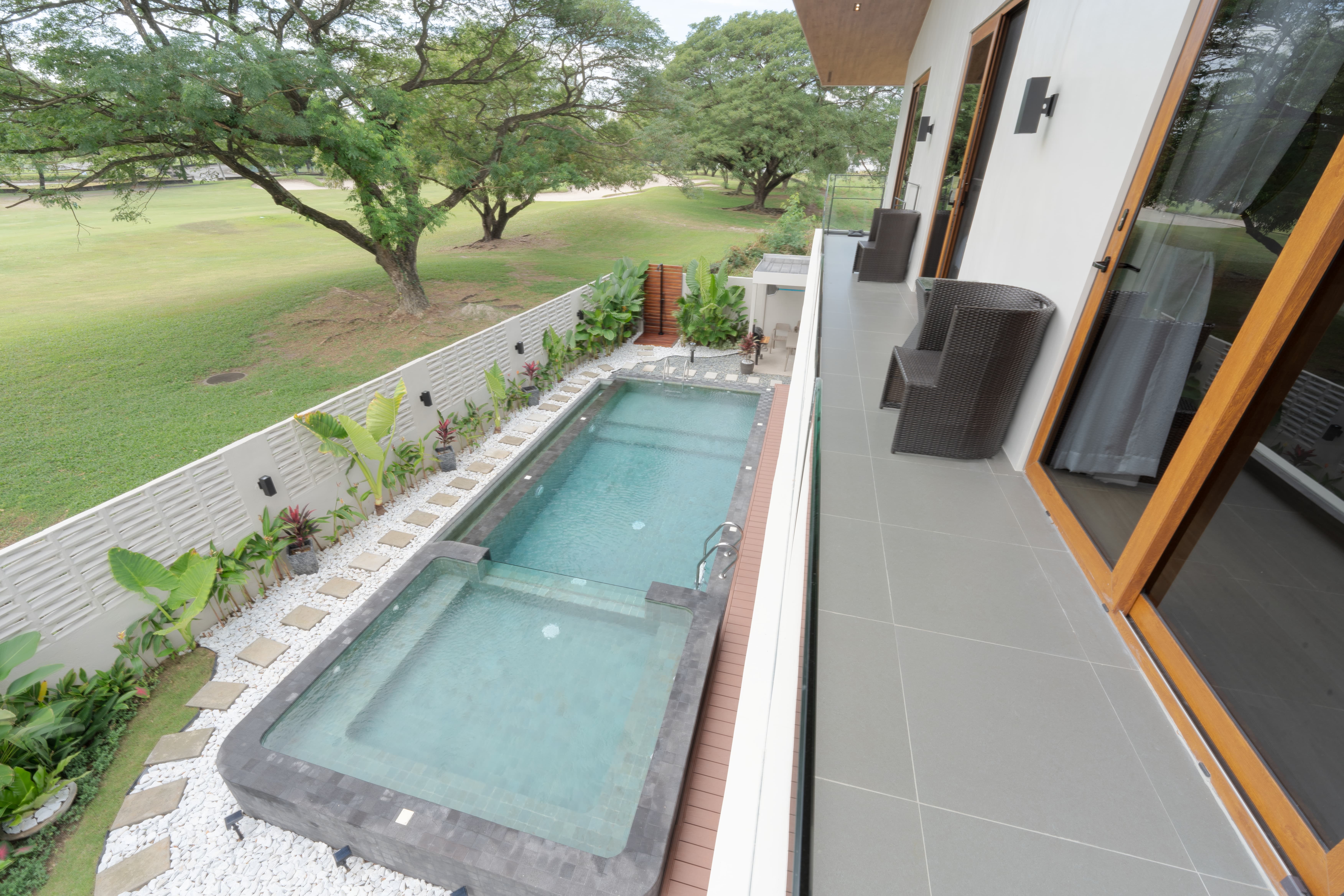 Pool and deck during the day, with the fairway in the background